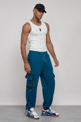 Оптом Широкие спортивные брюки трикотажные мужские синего цвета 12908S в Оренбурге, фото 3