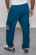 Оптом Широкие спортивные брюки трикотажные мужские синего цвета 12908S в Перми, фото 7