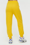 Оптом Спортивные брюки женские желтого цвета 1306J в Санкт-Петербурге, фото 10