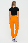 Оптом Спортивные брюки женские оранжевого цвета 1306O в  Красноярске, фото 5