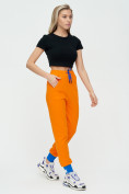 Оптом Спортивные брюки женские оранжевого цвета 1307O в Екатеринбурге, фото 3