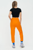 Оптом Спортивные брюки женские оранжевого цвета 1307O в Казани, фото 5